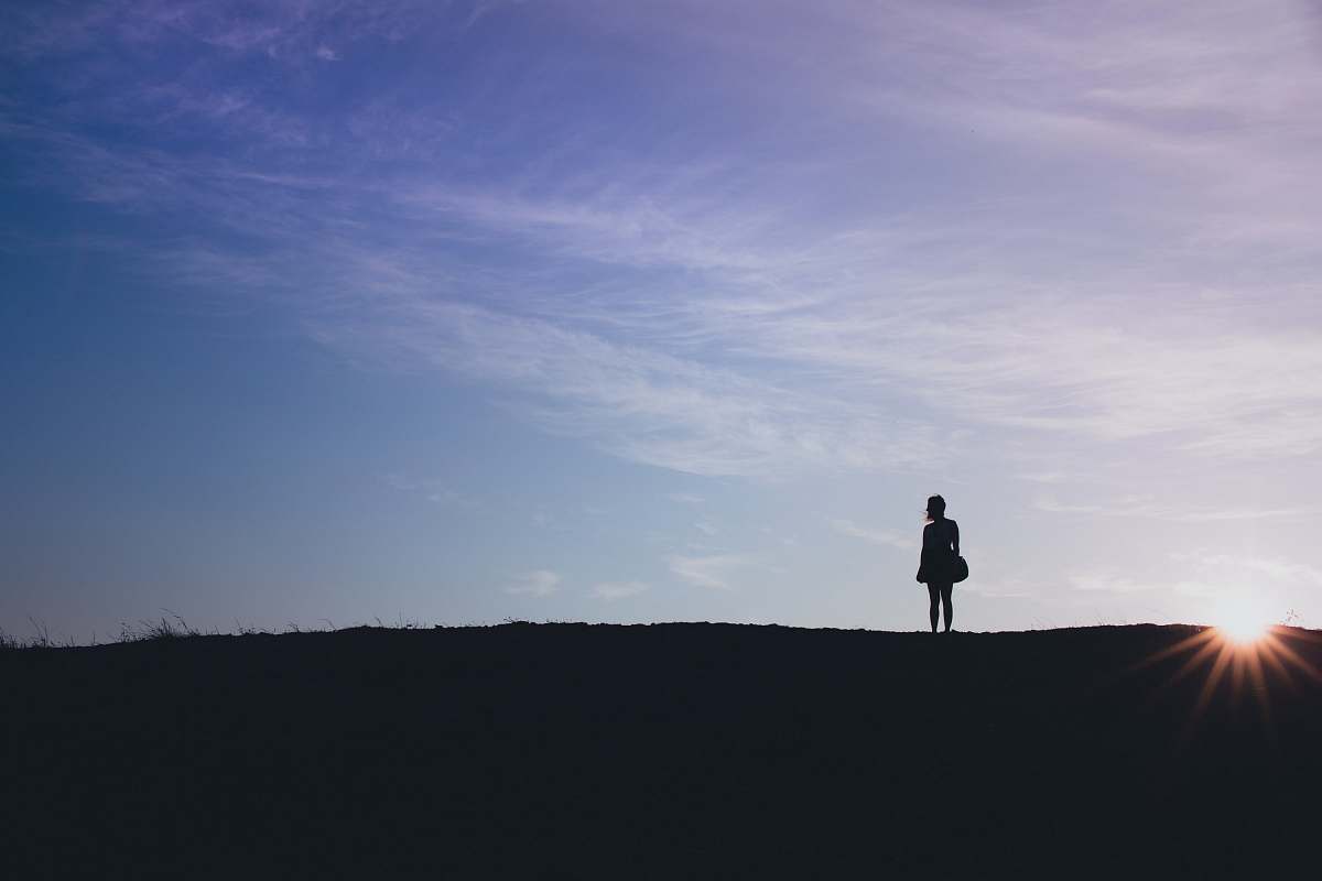 san francisco person's silhouette standing on field sun